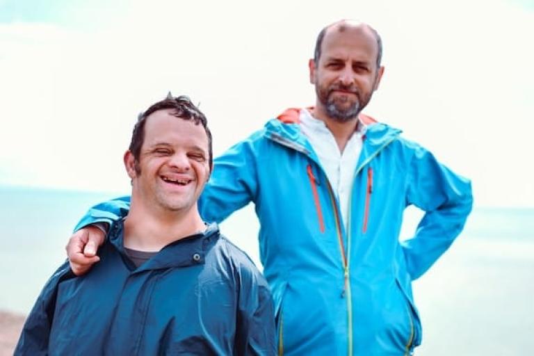 man with his arm on shoulder of younger man