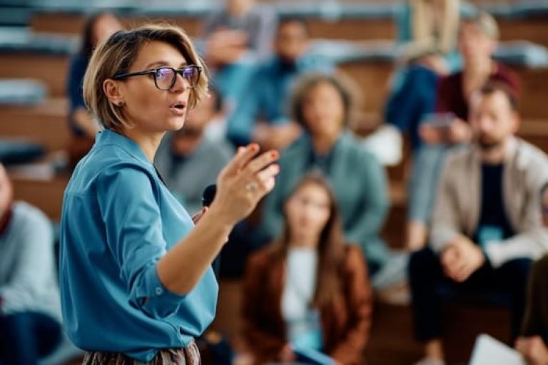 Woman lecturing class of students
