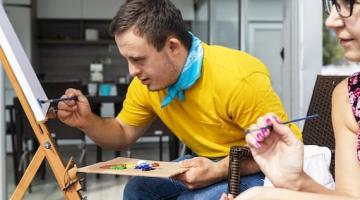 Teenage boy with downs syndrome painting