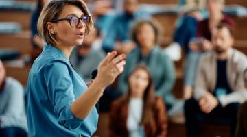 Woman lecturing class of students